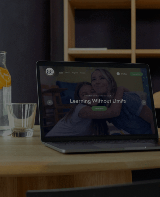 Laptop open on table to LC Learning Services Homepage