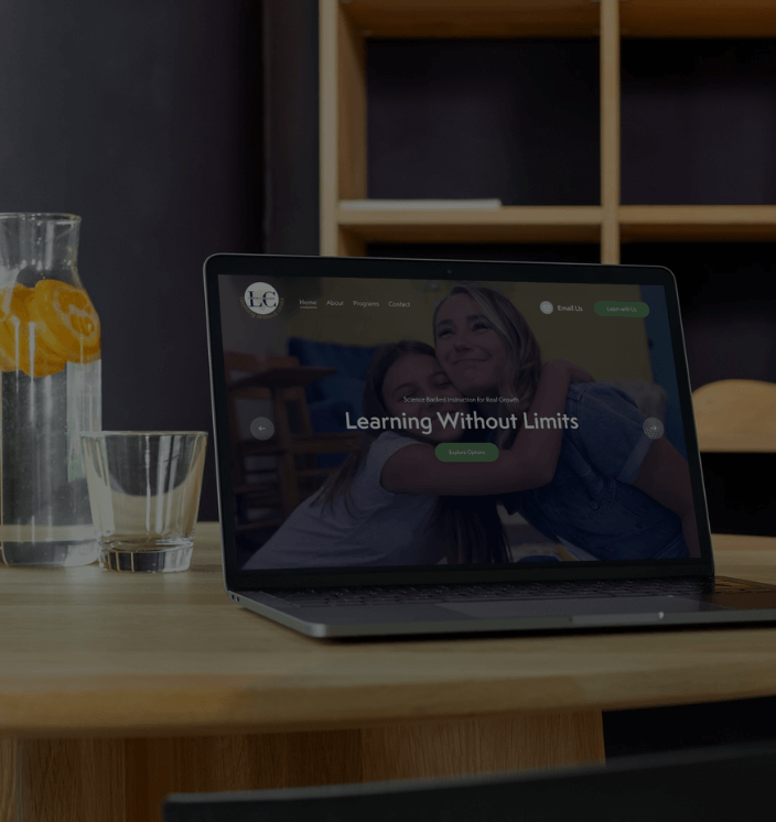 Laptop open on table to LC Learning Services Homepage