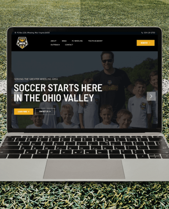 Laptop open on soccer field