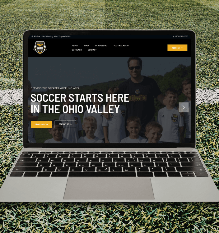 Laptop open on soccer field